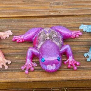 3 resin frogs sitting on the porch